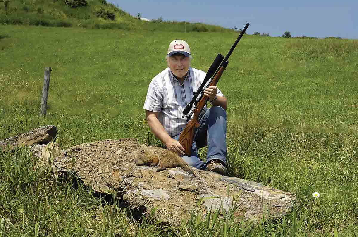 With his Remington Model 700 Varmint chambered in the 6mm Remington, from a braced rest in the foreground, the chuck was taken at the grass line just over the top of the fencepost in the left of the photo.